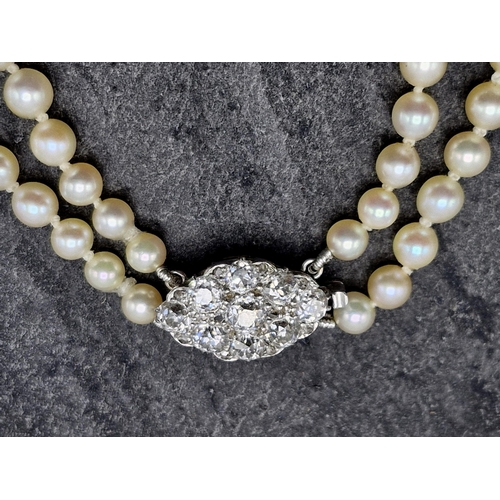 77 - Mid 20th century graduated double row pearl necklace with good diamond and platinum clasp, the clasp... 