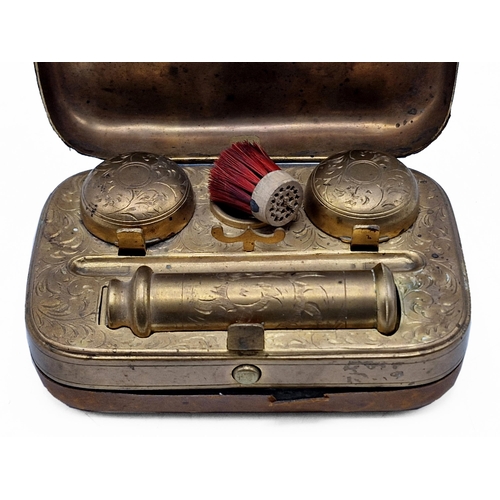 254 - Victorian leather and brass travel inkwell, interior having ornate scrolling throughout with inkwell... 