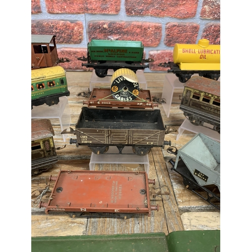 597 - Quantity of vintage Hornby 'O' gauge tin plate train wagons with additional trailers and signal post