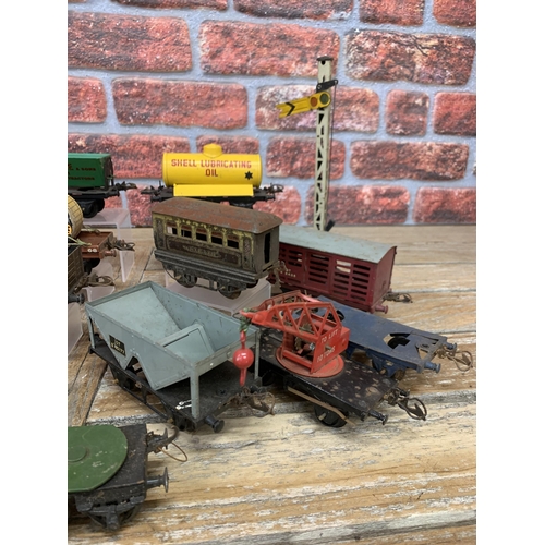 597 - Quantity of vintage Hornby 'O' gauge tin plate train wagons with additional trailers and signal post