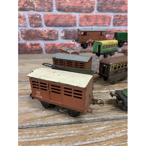 597 - Quantity of vintage Hornby 'O' gauge tin plate train wagons with additional trailers and signal post