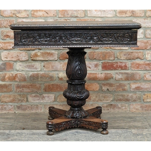 1280 - Anglo Indian carved ebony fold over top card table with turned baluster column, raised on a quadrupe... 