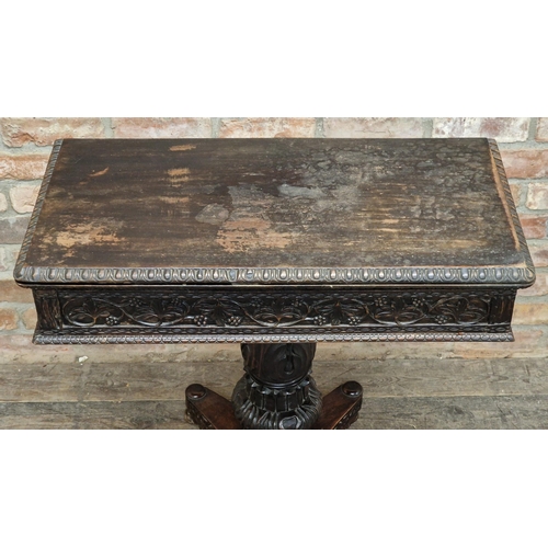 1280 - Anglo Indian carved ebony fold over top card table with turned baluster column, raised on a quadrupe... 