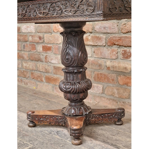 1280 - Anglo Indian carved ebony fold over top card table with turned baluster column, raised on a quadrupe... 