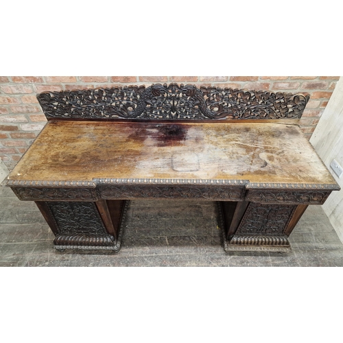 1291 - Anglo Indian profusely carved hard wood pedestal desk with gallery back, raised on turned supports, ... 