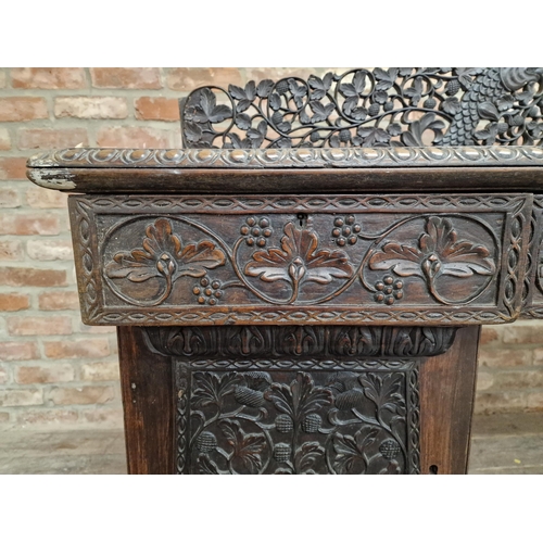 1291 - Anglo Indian profusely carved hard wood pedestal desk with gallery back, raised on turned supports, ... 