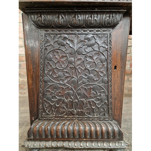 1291 - Anglo Indian profusely carved hard wood pedestal desk with gallery back, raised on turned supports, ... 