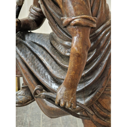 1296 - Interesting antique carved wooden statue of a cobbler raised on a simulated rock formation pedestal,... 