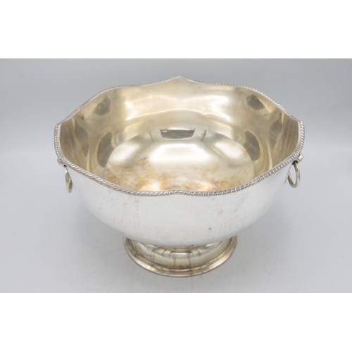 161 - Large silver plate punch bowl with fluted rim and lion head handles, raised atop circular foot, H 20... 