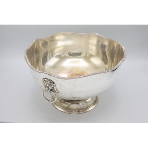 161 - Large silver plate punch bowl with fluted rim and lion head handles, raised atop circular foot, H 20... 