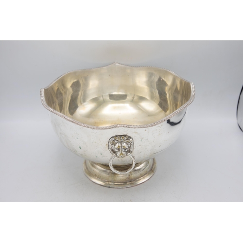 161 - Large silver plate punch bowl with fluted rim and lion head handles, raised atop circular foot, H 20... 