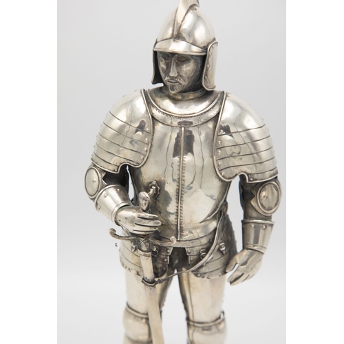 192 - Well modelled early 20th century silver figure of a standing knight, in traditional armour with swor... 