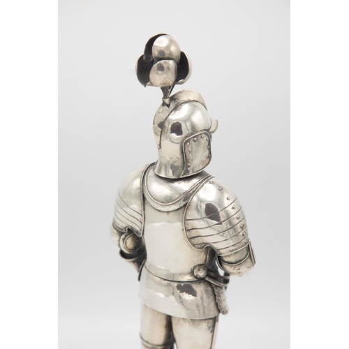 192 - Well modelled early 20th century silver figure of a standing knight, in traditional armour with swor... 