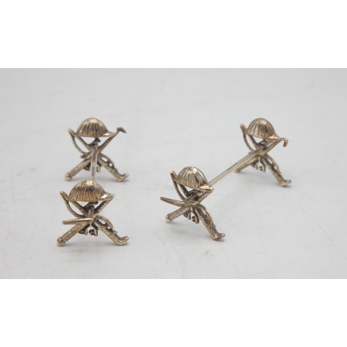 207 - Polo Interest - Novelty pair of equestrian spoon rests, with hat, crop, whip and stirrup detail, mak... 