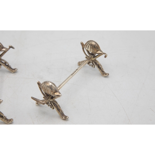 207 - Polo Interest - Novelty pair of equestrian spoon rests, with hat, crop, whip and stirrup detail, mak... 