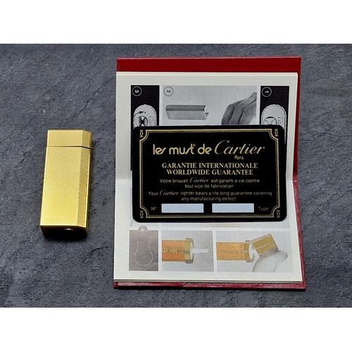 256 - Les Must De Cartier Gold Plate Briquet Lighter, to include box, authentication and additional flints