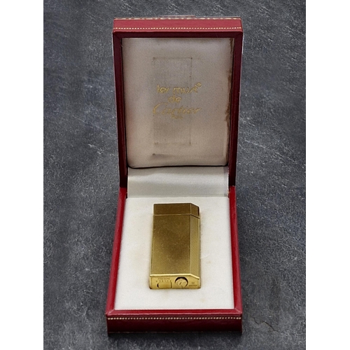 256 - Les Must De Cartier Gold Plate Briquet Lighter, to include box, authentication and additional flints