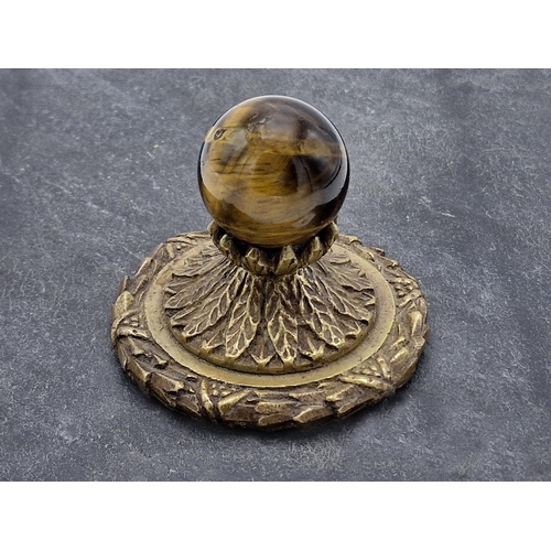 245 - Victorian brass and tigers eye desktop paperweight, signed H.H Craig, H 8cm