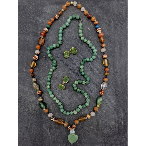 129 - Carved jade bead necklace, hand knotted, 55cm long with a further jade and amber type bead necklace ... 