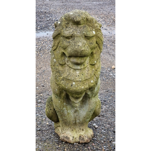 1024 - Weathered reconstituted stone garden statue of a seated lion, H 62cm