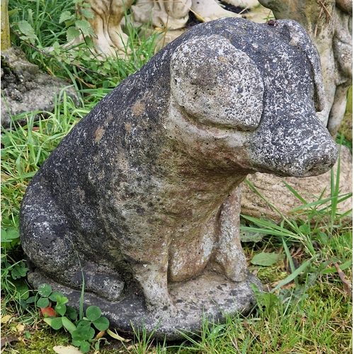 1027 - Weathered reconstituted stone garden ornament of a pig, H 40cm