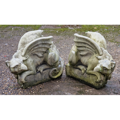 1034 - Pair of good quality weathered reconstituted stone garden ornament of mythical griffins, H 40cm (2)