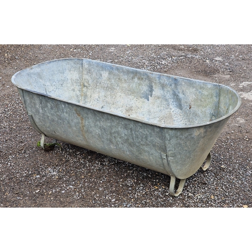 1038 - Vintage galvanised bath raised on strapwork supports, H 46cm x W 143cm x D 60cm