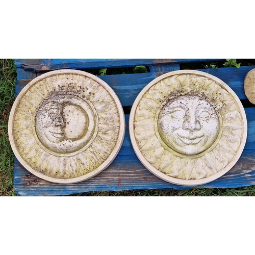 1044 - Two reconstituted stone circular wall plaques depicting a stylised sun and moon, H 37cm (2)