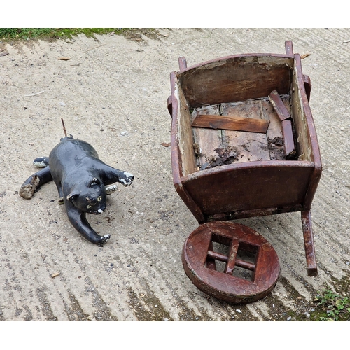 1054 - Painted reconstituted stone cat garden ornament, together with a vintage wheelbarrow (AF) (2)