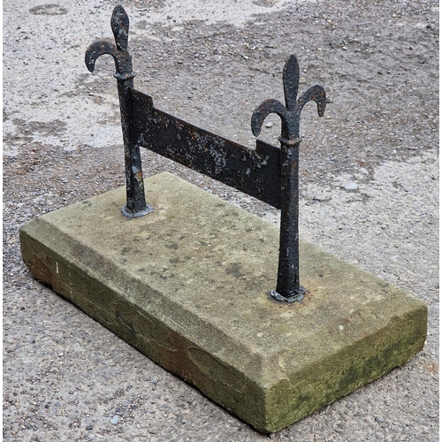 1058 - Antique painted iron boot scraper set in a chamfered stone block, H 45cm x W 61cm x D 32cm