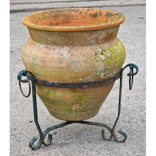 1080 - Good weathered terracotta planter with incised decoration raised on a painted metal scrollwork stand... 