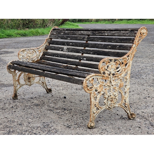 1105 - Victorian painted cast iron garden bench with slatted seat and scrolling pierced detail, H 80cm x W ... 