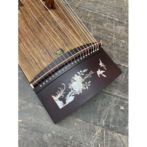 409 - Chinese Guzheng 21 string zither harp instrument, having a peacock and floral decoration, L 165cm