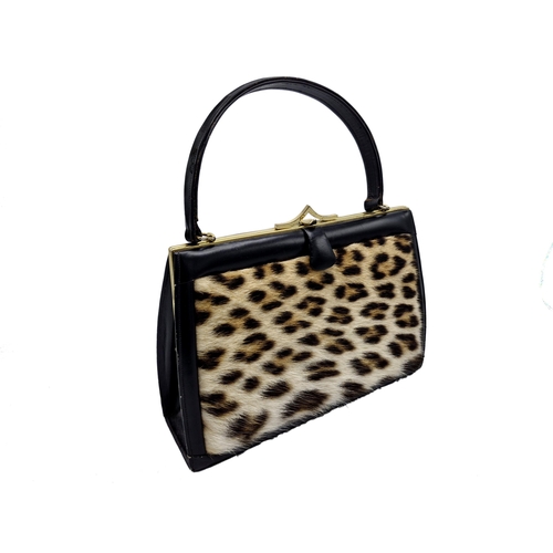 292 - Hand made ocelot fur and brass clasp handbag, 29cm x 20cm