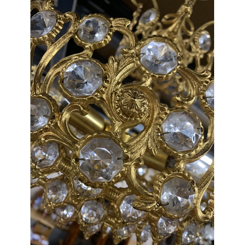 1410 - Gilt metal and crystal glass ceiling chandelier, having an ornate multi tiered scrolled frame, D 40c... 