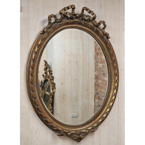 1443 - Large French gilt oval wall mirror with ribbon and bobbin detail, H 133cm x W 97cm