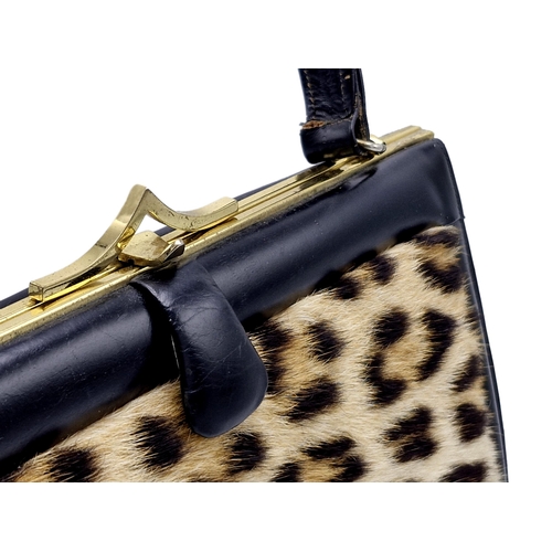 292 - Hand made ocelot fur and brass clasp handbag, 29cm x 20cm