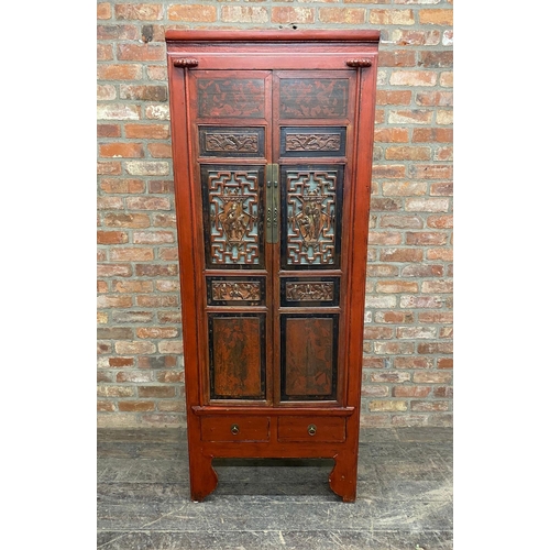 1234 - Chinese red laquered cabinet, twin doors pierced and carved with figures, enclosing shelves, two dra... 