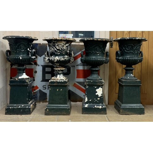 1134 - A good quality rare set of four Victorian cast iron Campana urns on pedestals, with twin mask loop h... 