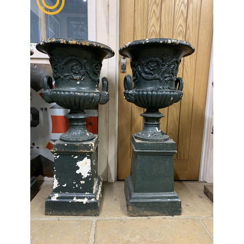 1134 - A good quality rare set of four Victorian cast iron Campana urns on pedestals, with twin mask loop h... 