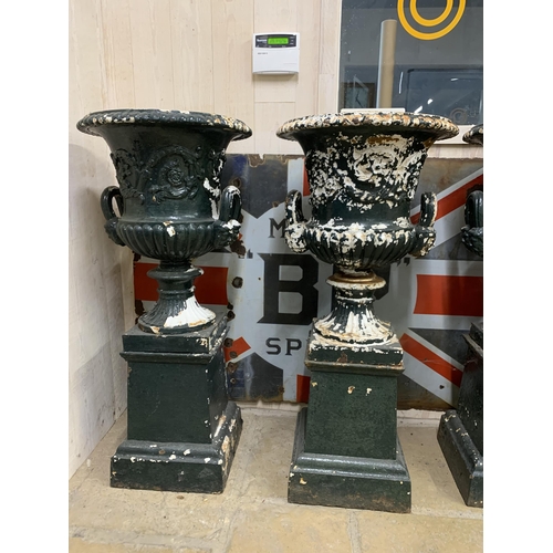 1134 - A good quality rare set of four Victorian cast iron Campana urns on pedestals, with twin mask loop h... 