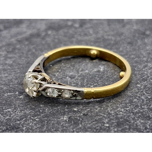 125 - Antique high carat unmarked gold and diamond ring, central 0.40ct old cut diamond flanked by four fu... 