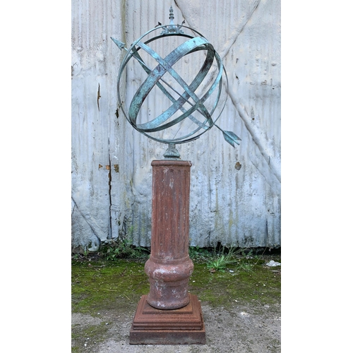 1164 - Good patinated bronze armillary sphere cast with dolphins and finial, upon a cast iron fluted column... 