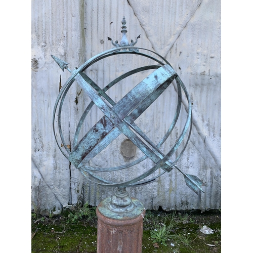 1164 - Good patinated bronze armillary sphere cast with dolphins and finial, upon a cast iron fluted column... 