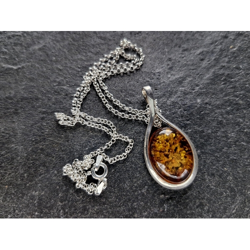 57 - Collection of silver and amber jewellery - pendant and chain, butterfly pendant and chain, cat brooc... 