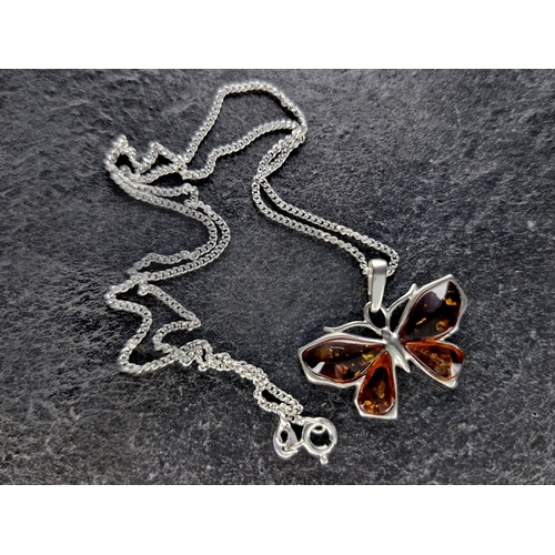 57 - Collection of silver and amber jewellery - pendant and chain, butterfly pendant and chain, cat brooc... 