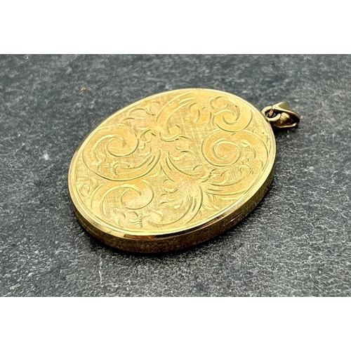 115 - 9ct locket pendant, engraved with scrolled acanthus, 4 x 3cm, 13.2g