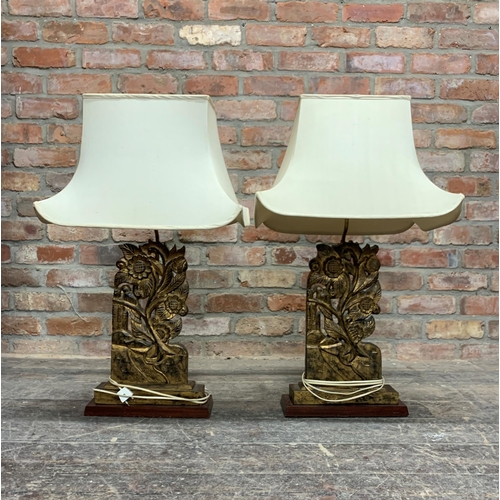 1418 - Pair of Chinese carved gilt wood floral panels converted into table lamps, with cloth shades, 85cm