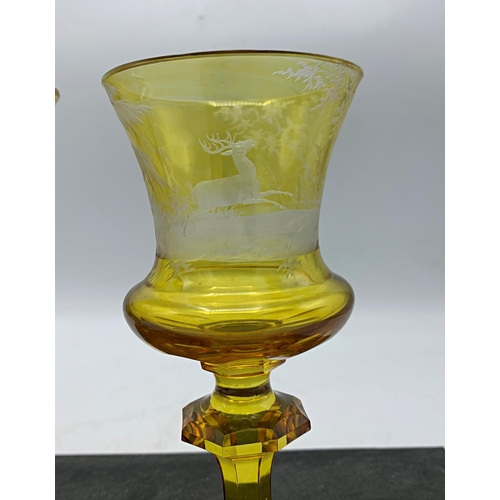 489 - Good quality pair of Bohemian amber glass goblet, etched with a stag hunting scene, 17.5cm high (2)