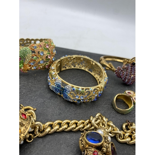 149 - Collection of Butler and Wilson type costume jewellery, comprising three bangles, two rings and curb... 